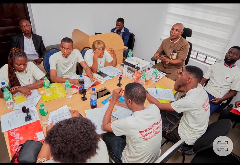 Group of people gathered around a table with art supplies, engaged in a creative workshop or team-building activity